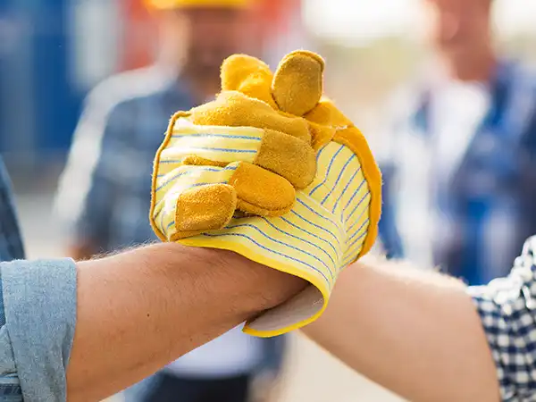 workers clasping hands