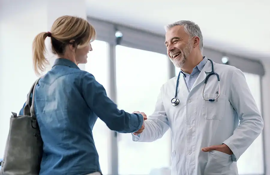 Medical scrubs and stethoscope hanging on wall